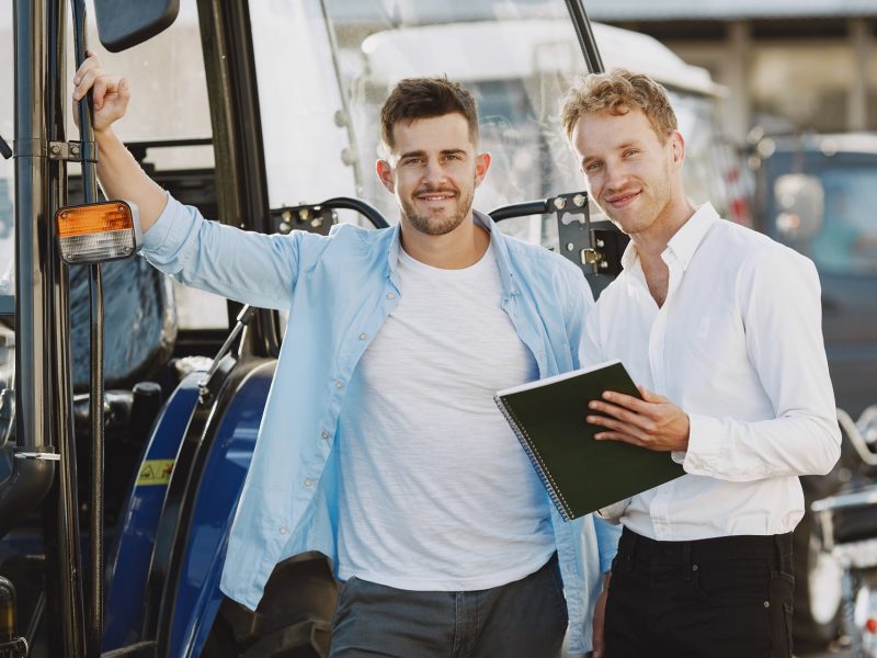 Agronomist choosing a new planter. Man at the outdoor ground of the shop. Agricultural machinery.